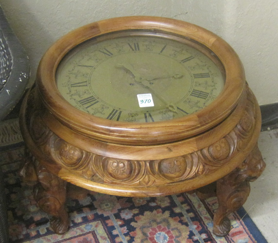 Appraisal: ROUND CLOCK COFFEE TABLE featuring a spring wound time strike