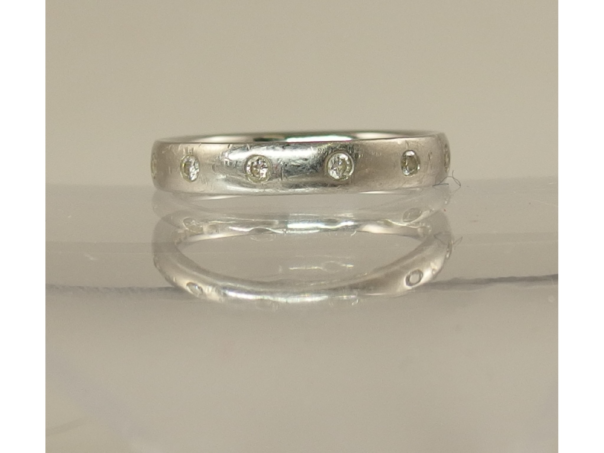 Appraisal: A platinum diamond set wedding band