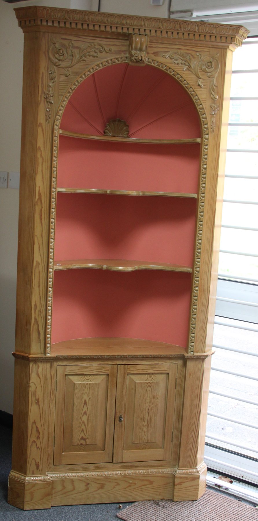 Appraisal: A pine corner shelf with carved dentil cornice and acanthus