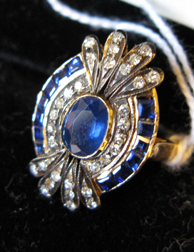 Appraisal: SAPPHIRE DIAMOND AND FOURTEEN KARAT GOLD RING centering an oval-cut