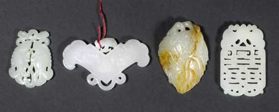 Appraisal: FOUR WHITE JADE PENDANTS TWINFISH FRUITS WITH RUSSET INCLUSIONS CHIME