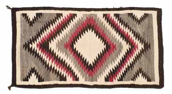 Appraisal: A Navajo Rug with eye dazzler design in red black