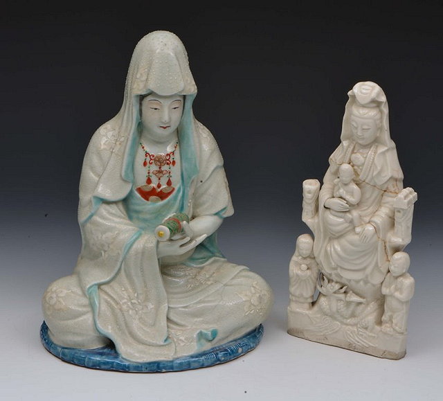 Appraisal: A CHINESE PORCELAIN SEATED POLYCHROME MODEL of GUANYIN holding a