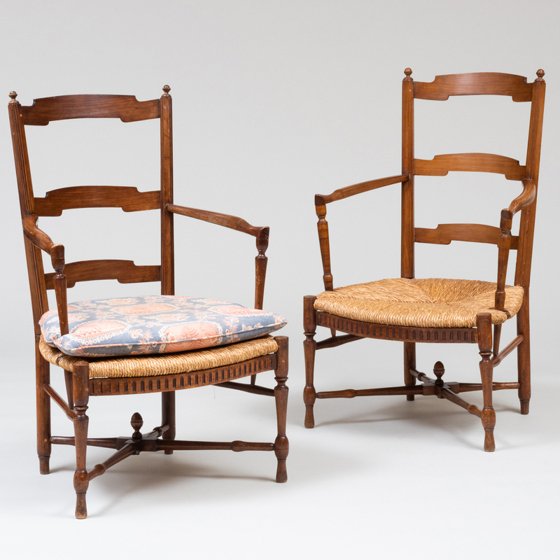 Appraisal: PAIR OF FRUITWOOD LADDER BACK ARMCHAIRS WITH RUSH SEATS x