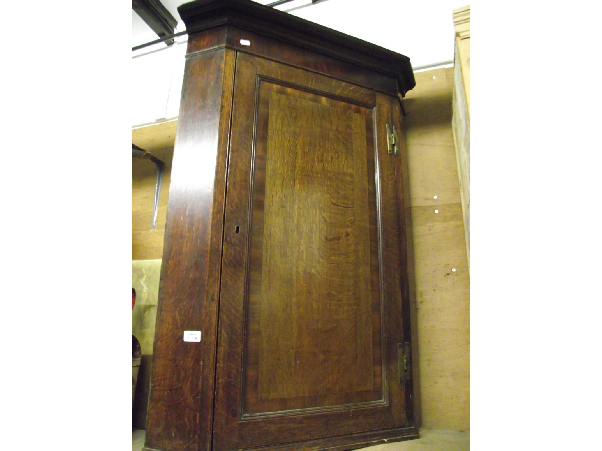 Appraisal: A th century oak hanging corner cupboard enclosed by a