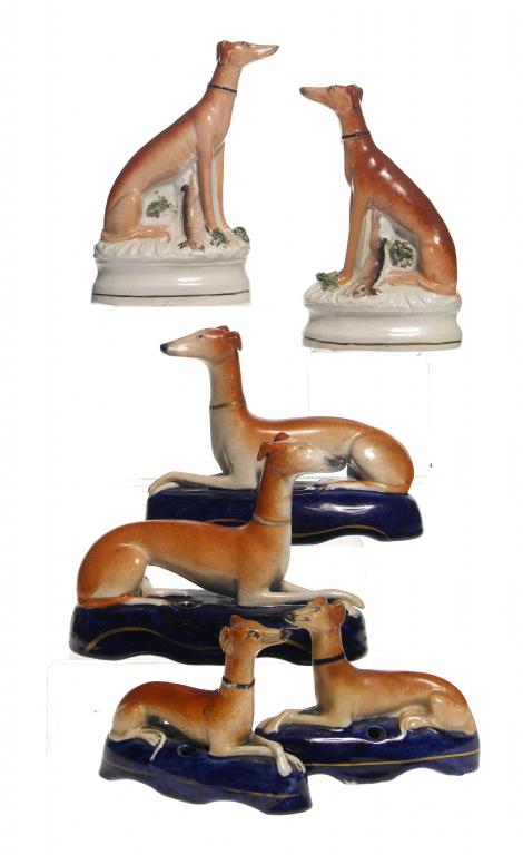 Appraisal: THREE PAIRS OF STAFFORDSHIRE EARTHENWARE MODELS OF SEATED OR RECUMBENT