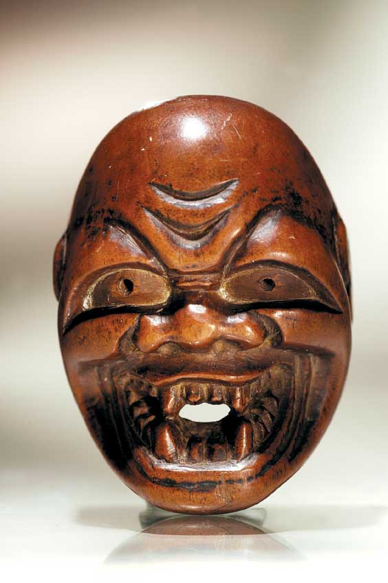 Appraisal: ANTIQUE WOOD MASK NETSUKE Antique carved wood mask netsuke with