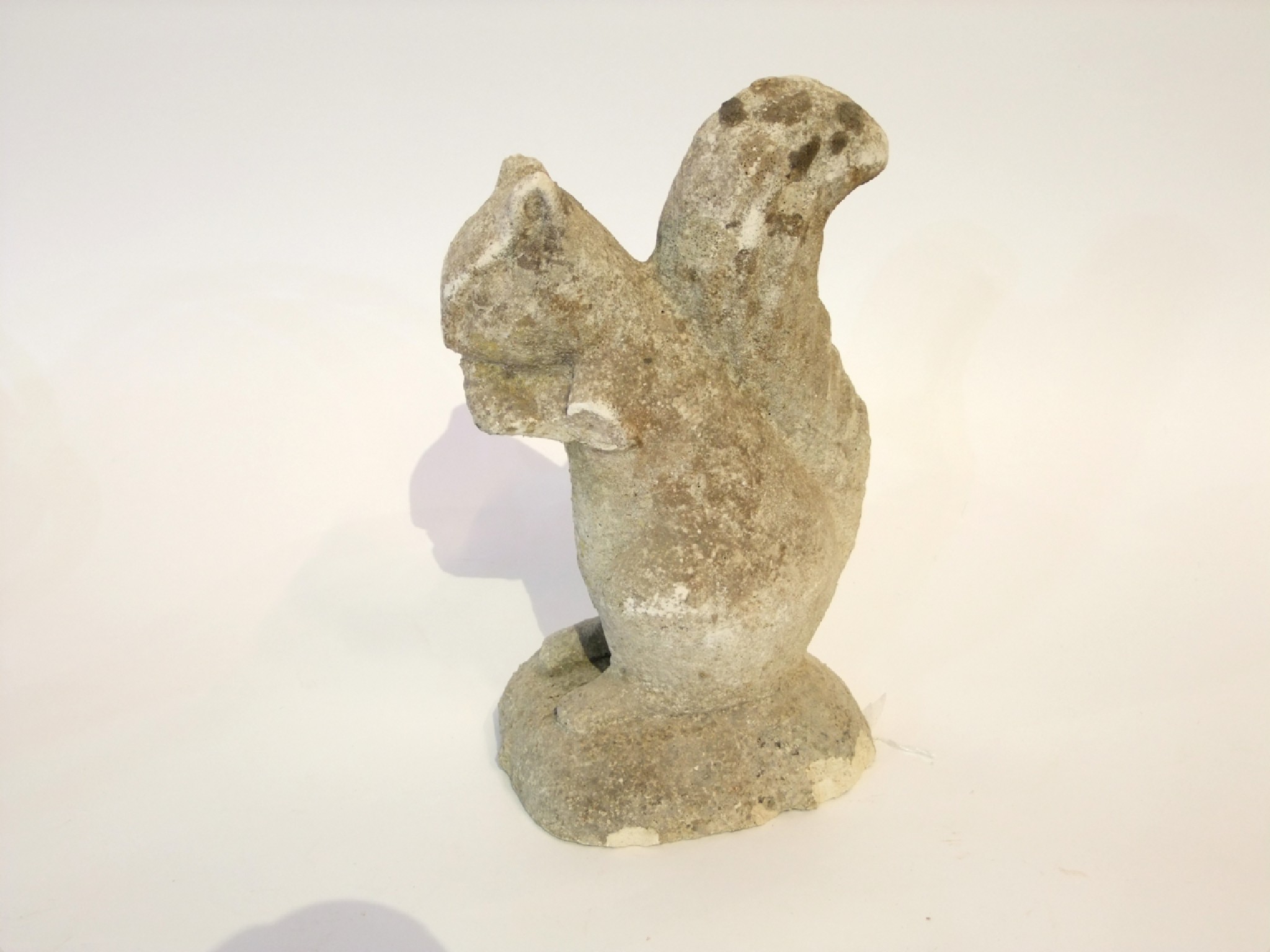 Appraisal: A decorative weathered composition stone model of a seated red