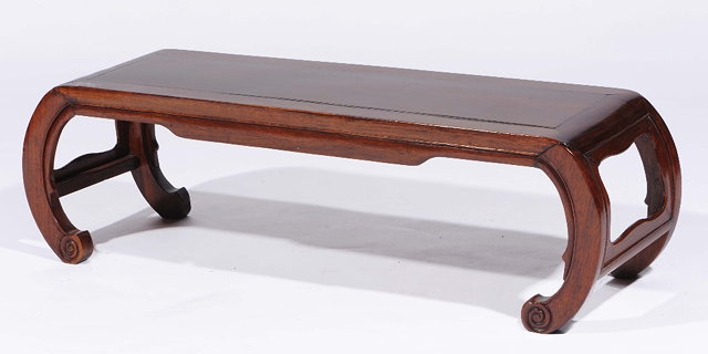 Appraisal: A Chinese hardwood low tableon curved supports cm across x