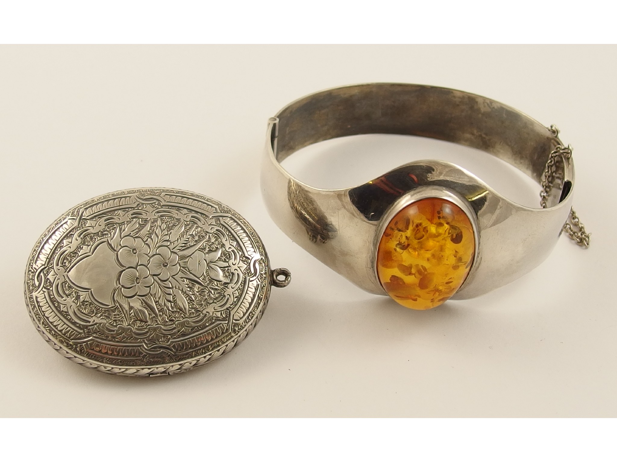 Appraisal: A silver bangle set with a large amber coloured stone