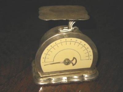 Appraisal: A PAIR OF EDWARDIAN POSTAL SCALES with semi circular ivorine