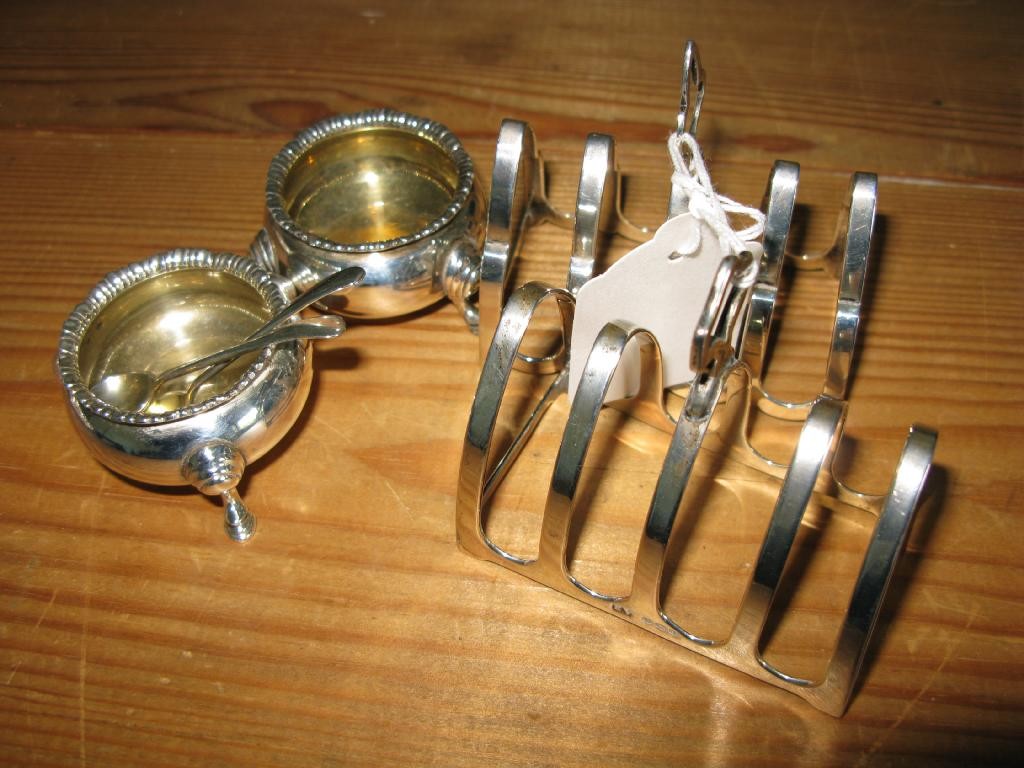 Appraisal: A pair of circular silver salts with original server spoons