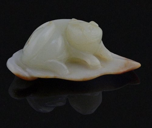 Appraisal: A Chinese celadon jade pebble carving of a cat on