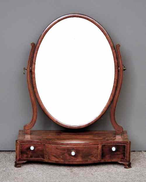 Appraisal: A mahogany oval toilet mirror of Sheraton design with shaped