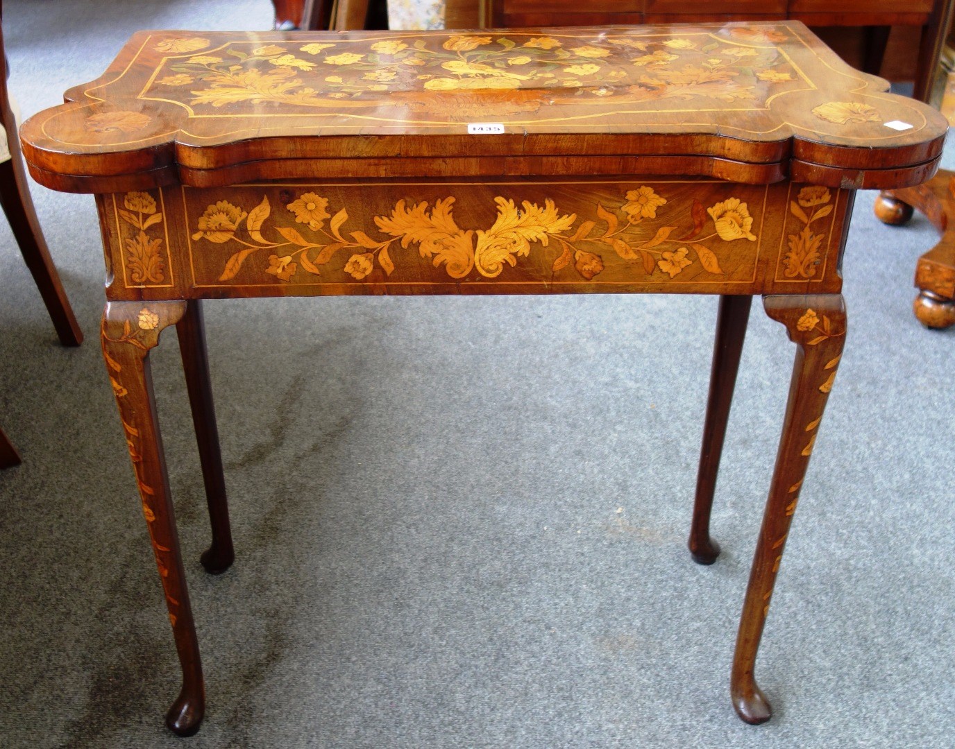 Appraisal: An th century marquetry inlaid Dutch walnut card table with