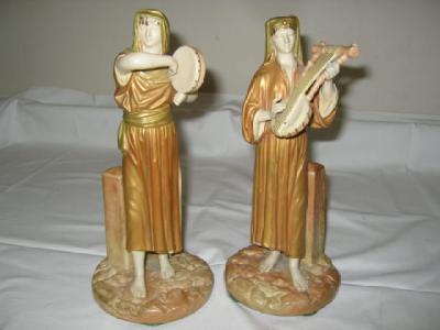 Appraisal: A PAIR OF ROYAL WORCESTER FIGURES of Eastern musicians playing