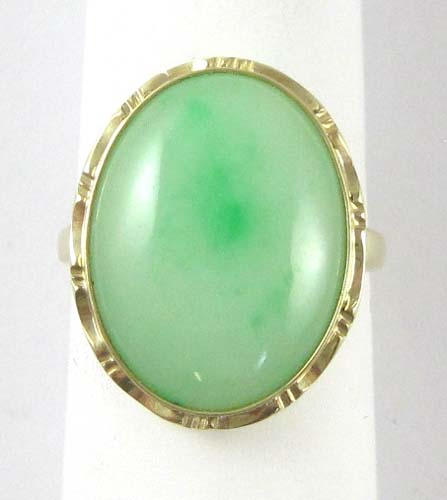 Appraisal: JADE AND FOURTEEN KARAT GOLD SOLITAIRE RING set with an