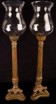 Appraisal: A pair of patinated metal candle holders of reeded column