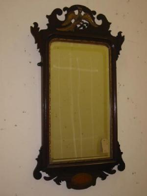 Appraisal: A MAHOGANY FRET FRAMED MIRROR the arched oblong bevelled plate