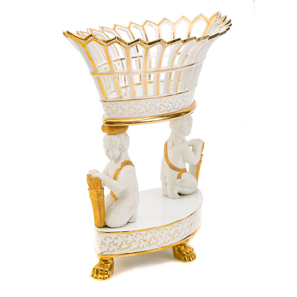 Appraisal: Porcelain de Paris figural compote pierced porcelain basket supported by