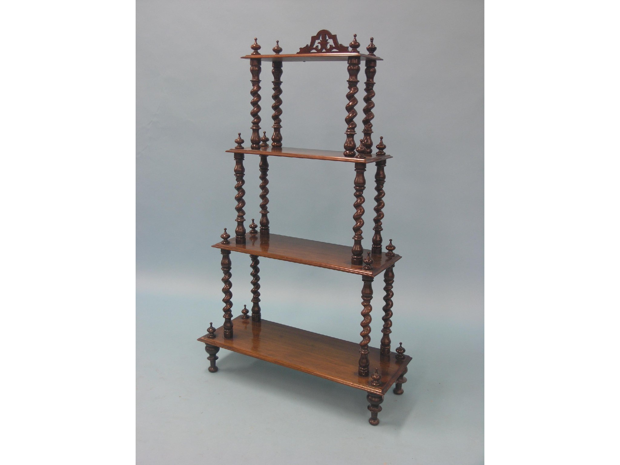 Appraisal: A Victorian walnut whatnot tapering in four tiers spiral-twist uprights