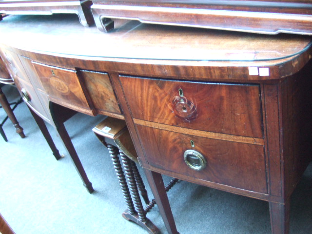 Appraisal: A George III mahogany bowfront sideboard the central drawer with