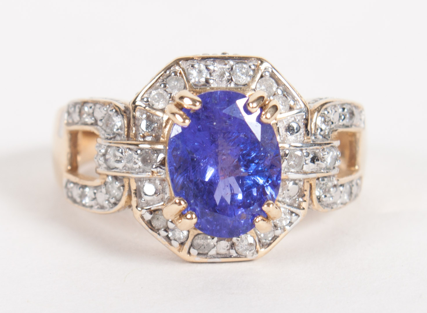 Appraisal: K gold tanzanite and diamond ring center oval tanzanite surrounded