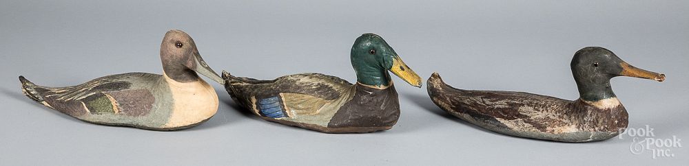 Appraisal: Three painted canvas duck decoys th c Three painted canvas