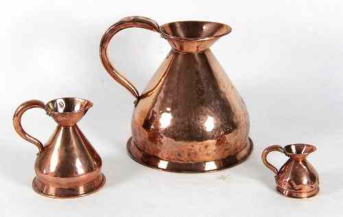 Appraisal: A copper gallon rum jug on a skirt base cm