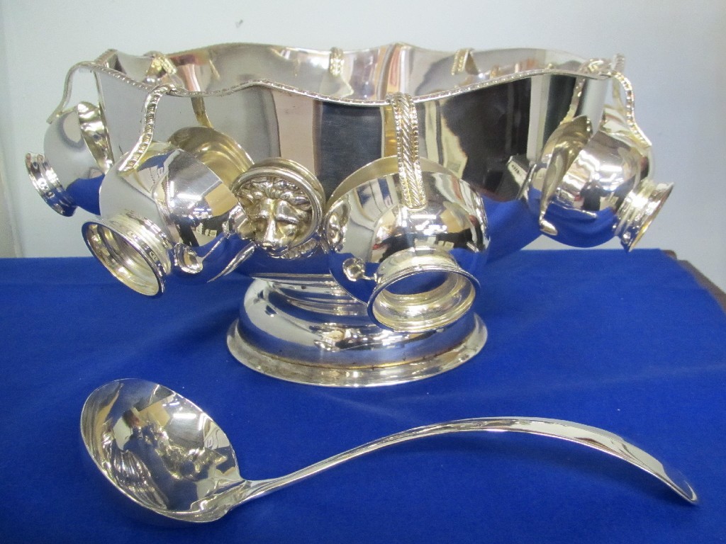 Appraisal: A large silver plate punch bowl with cups and ladle