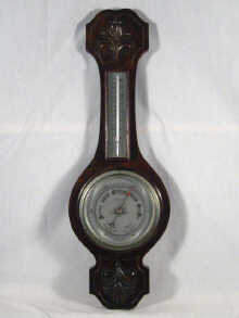 Appraisal: An aneroid barometer and mercury thermometer in a combined oak