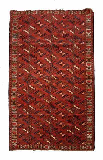 Appraisal: AN ESARI RUG th Century with ikat border and alternating