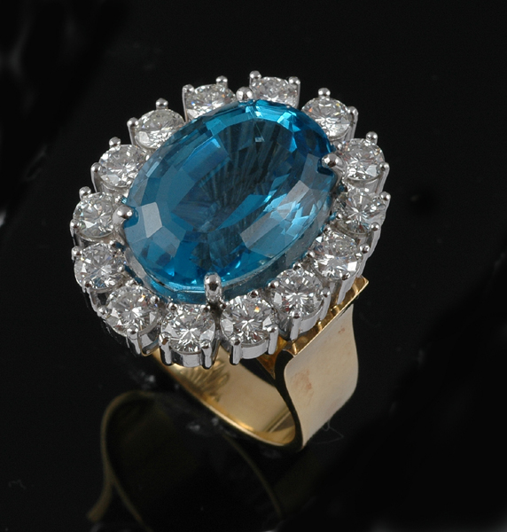 Appraisal: A BLUE TOPAZ AND DIAMOND CLUSTER RING Centrally set with