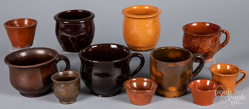 Appraisal: Redware mugs and small crocks th c Redware mugs and