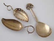 Appraisal: A leaf caddy spoon with tendril handle marked Sterling a