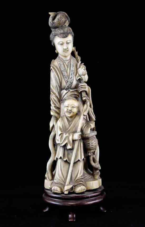 Appraisal: A large Chinese ivory group of a lady holding a