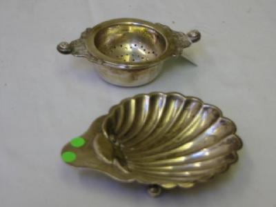 Appraisal: A BUTTER DISH of shell form with three ball feet