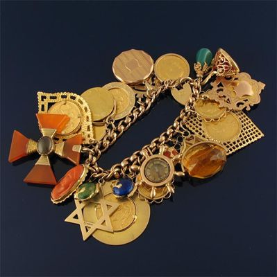 Appraisal: A ct gold bracelet with twenty three assorted charms including