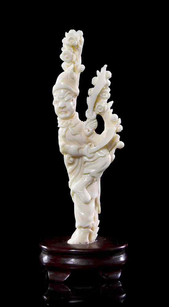 Appraisal: A White Coral Carving of a Warrior shown amongst flowering