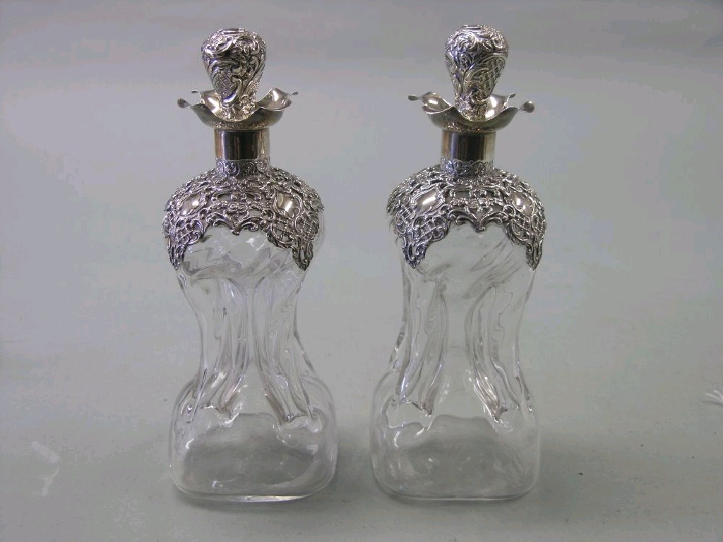 Appraisal: A pair of late Victorian pinched glass decanters each with