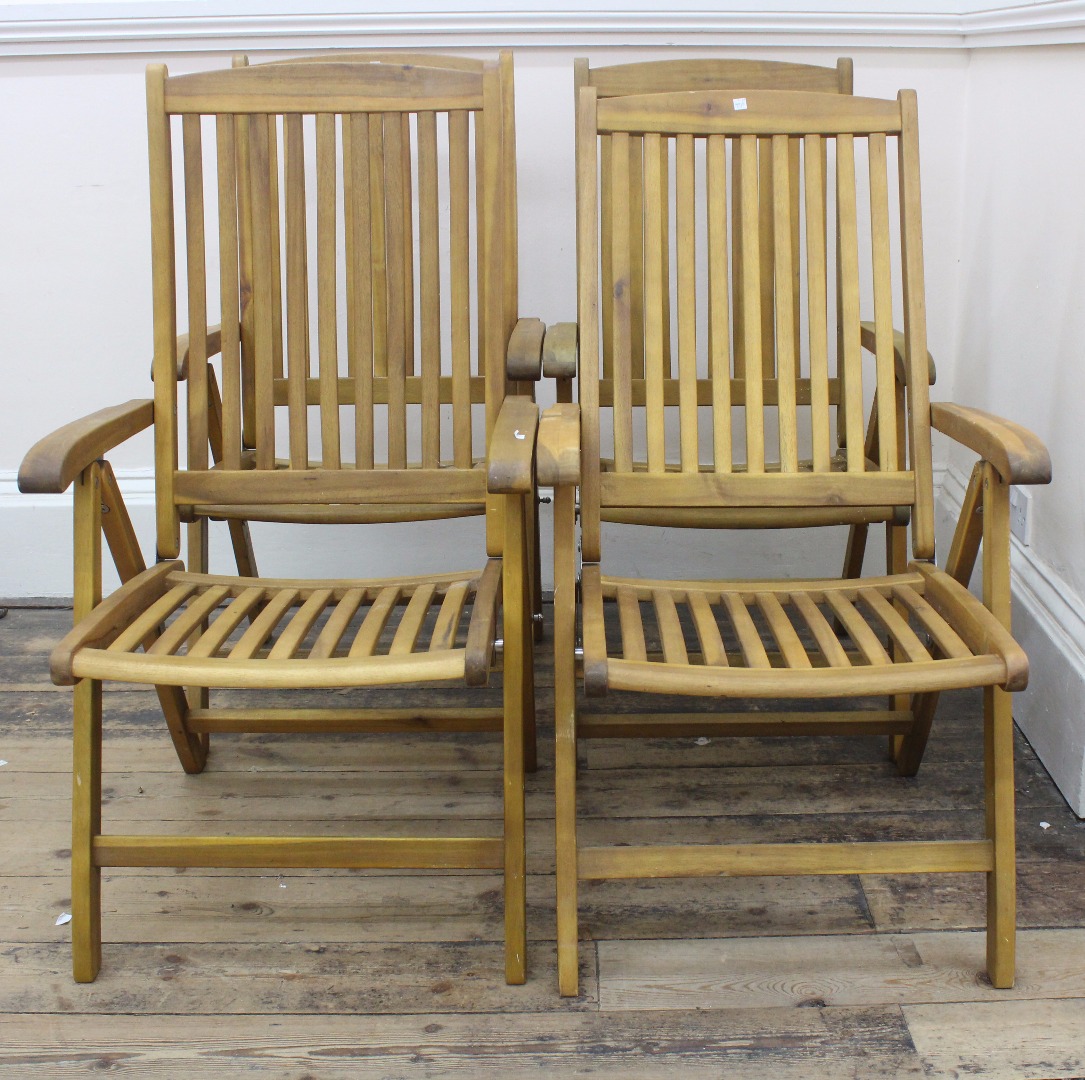 Appraisal: A set of four slatted hardwood folding garden chairs by