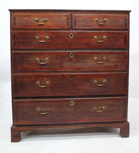 Appraisal: A GEORGE III OAK CHEST OF TWO SHORT AND FOUR