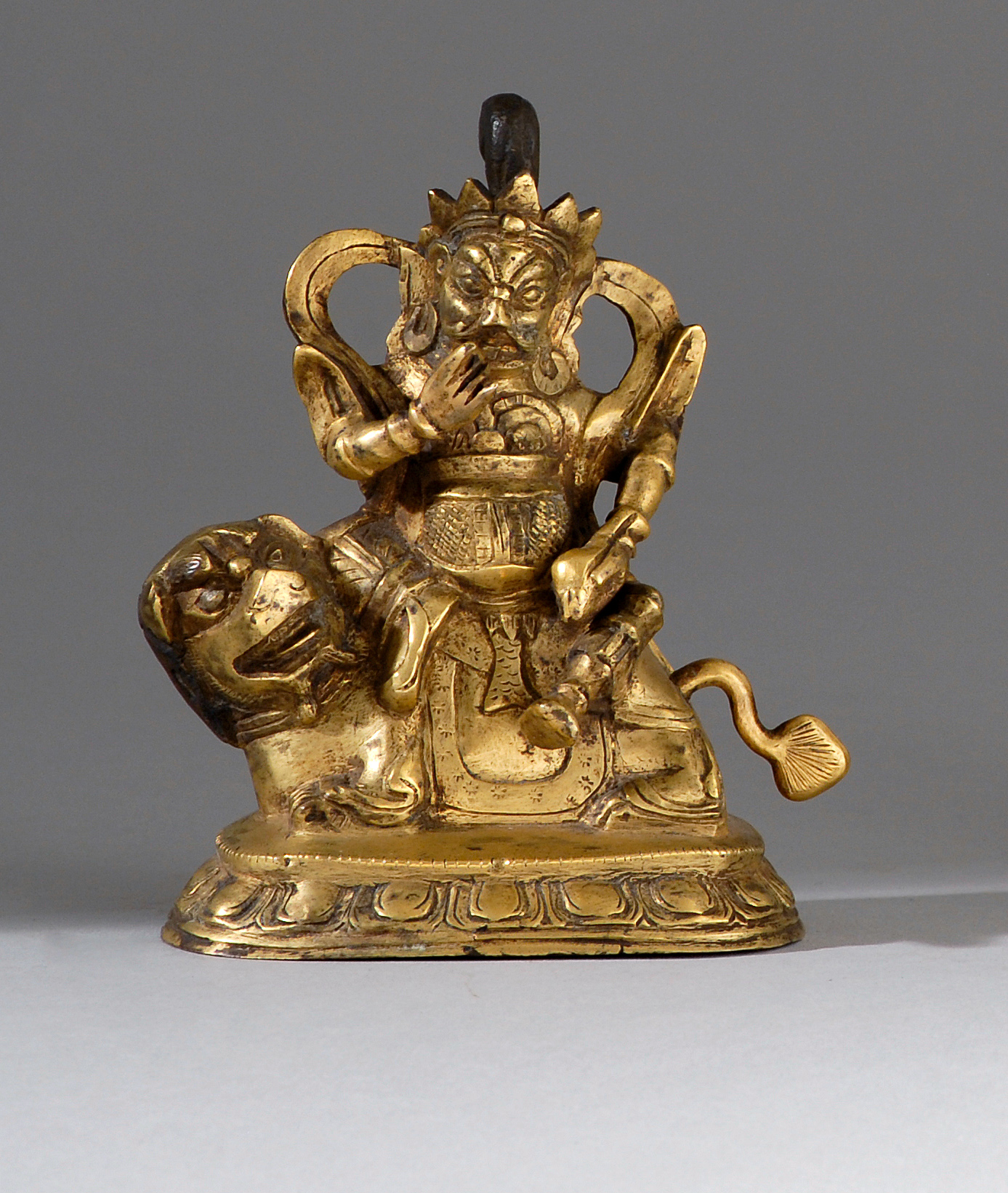 Appraisal: GILT-BRONZE FIGURE th th CenturyDepicting an armored deity seated on