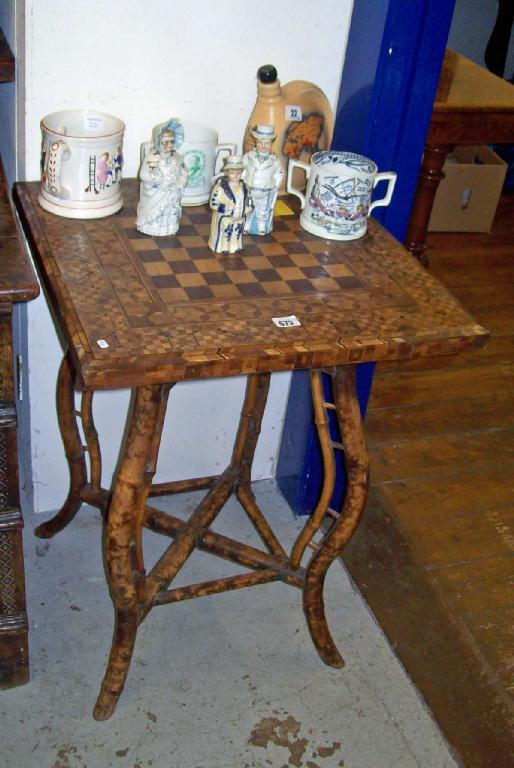 Appraisal: A Victorian bamboo table with parquetry chess board top -