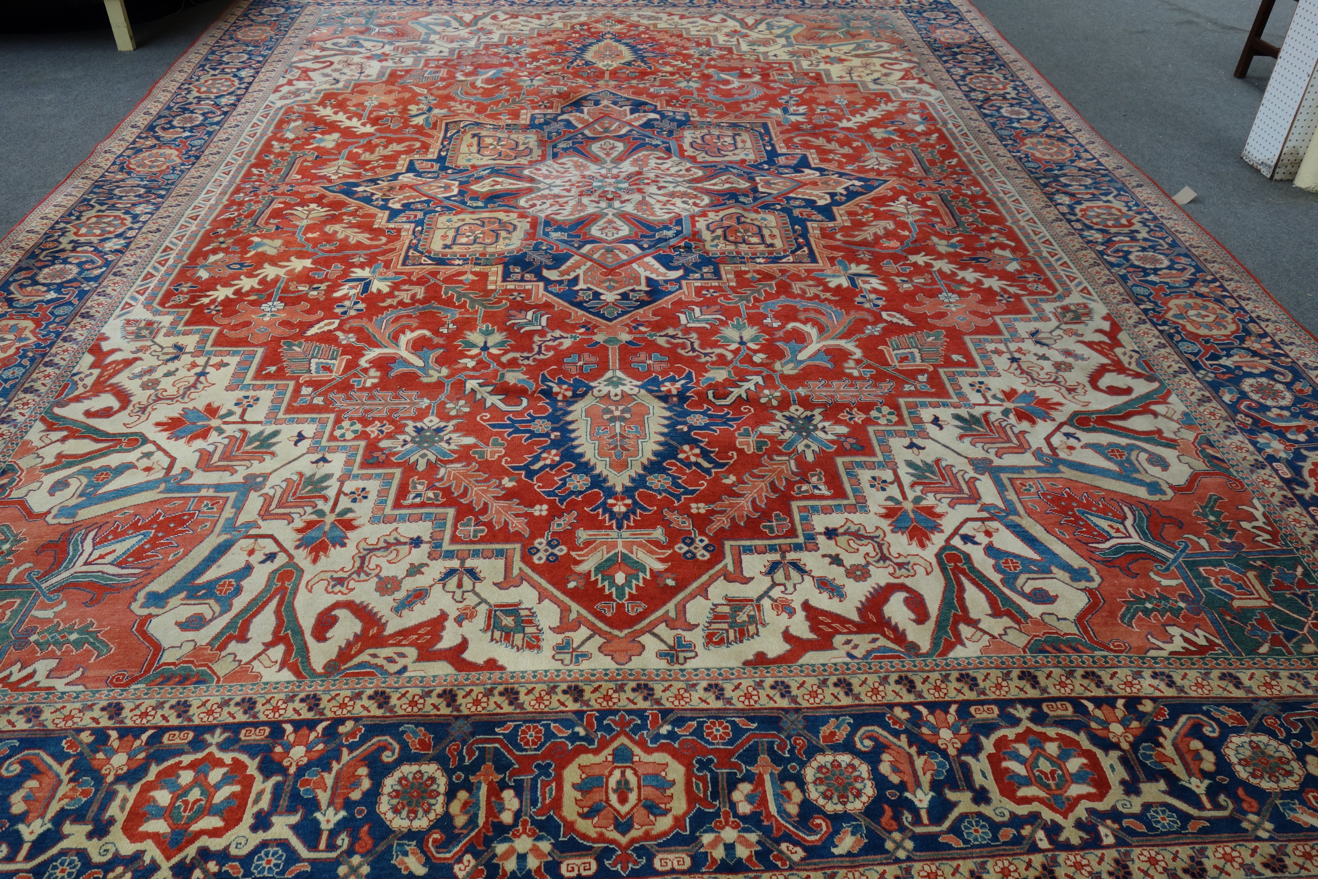 Appraisal: An Heriz carpet the red field with a central blue