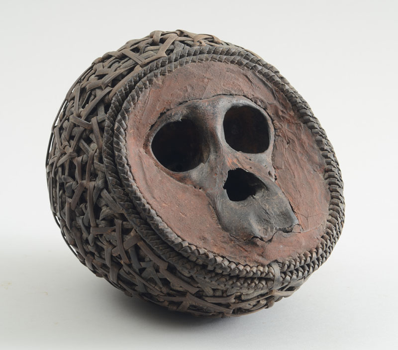 Appraisal: AFRICAN BABOON SKULL-INSET POTTERY AND WOVEN LATTICE BALL The concave