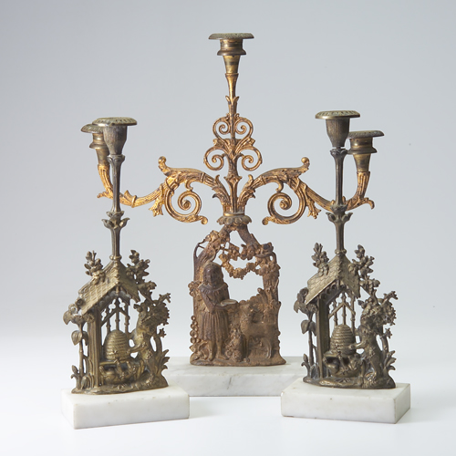 Appraisal: Three turn of the century bronze figural candle holders mounted