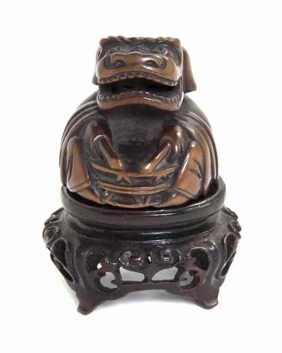 Appraisal: A Carved Wood Netsuke depicting a figure within a mask