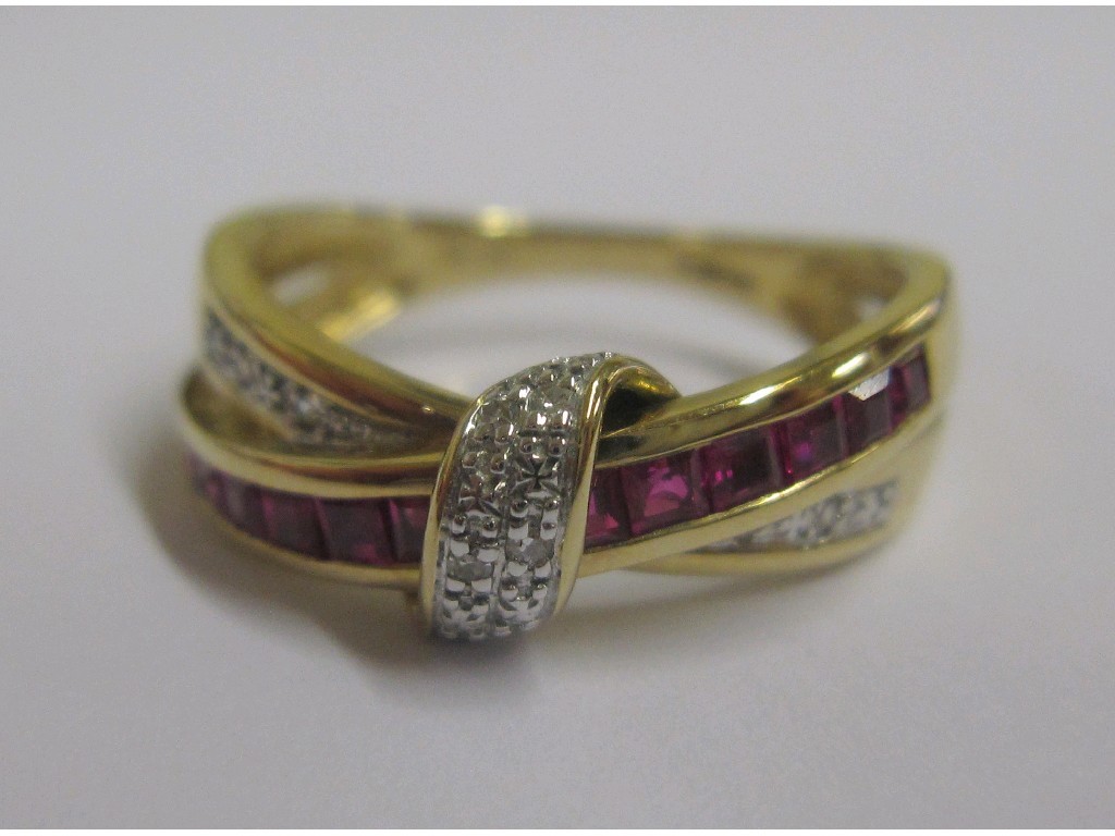 Appraisal: Nine carat gold ruby and diamond set cross over band