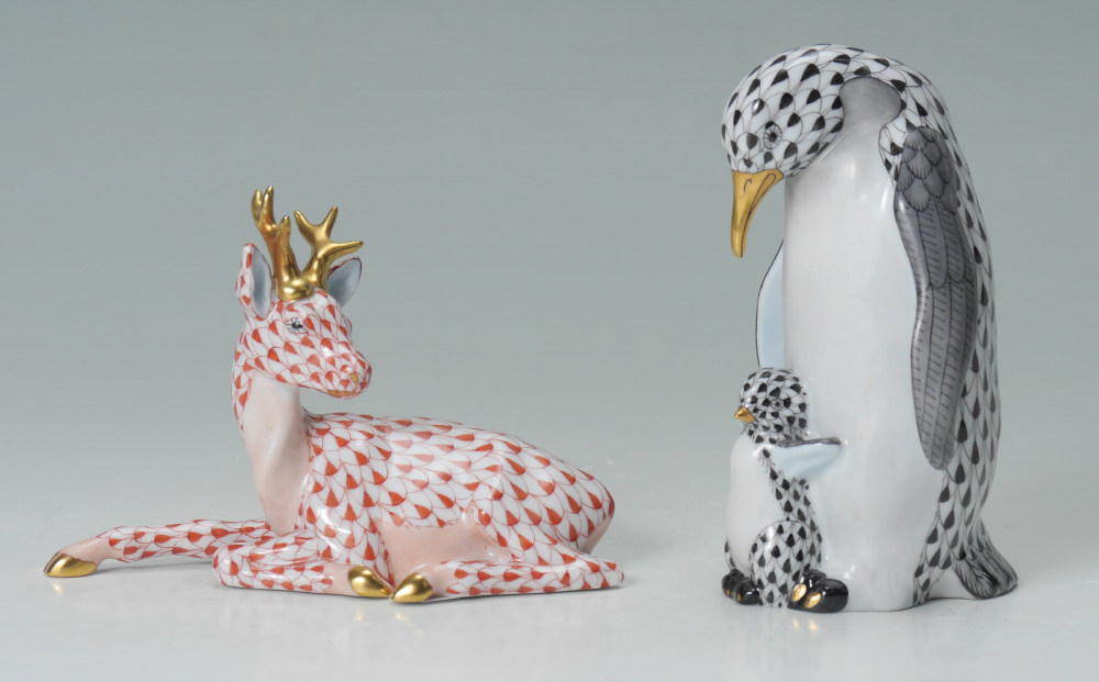 Appraisal: TWO HEREND PORCELAIN FIGURINES PENGUIN and baby black fishnet ''